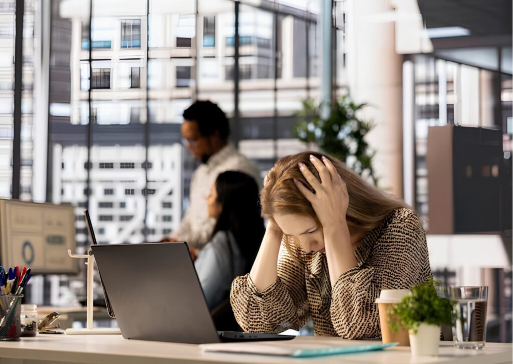 Working woman experiencing anxiety symptoms, chronic stress and emotional burnout.
